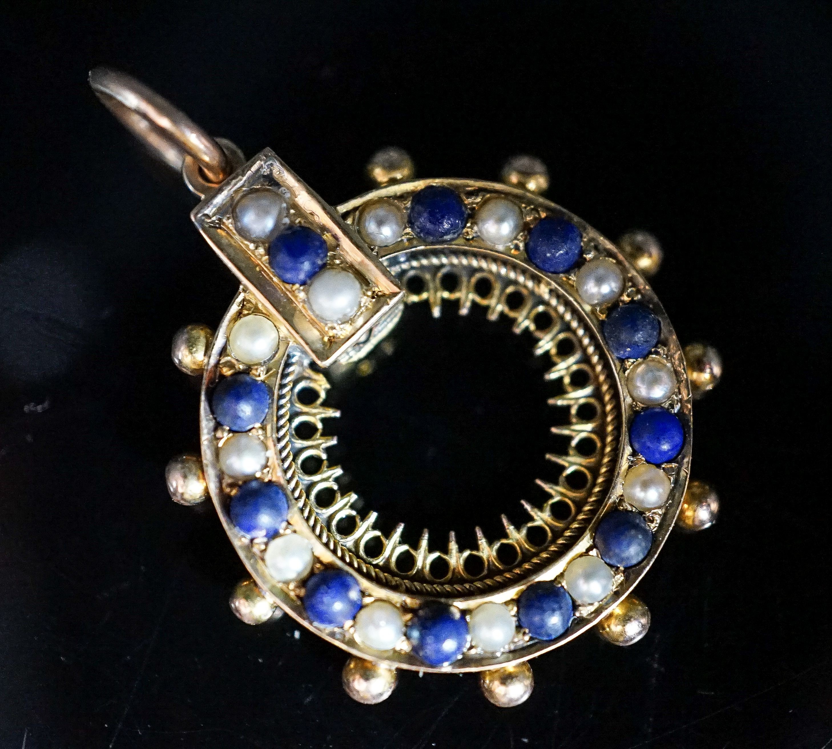 A yellow metal, lapis lazuli and split pearl set wheel pendant, 22mm, gross weight 3.4 grams